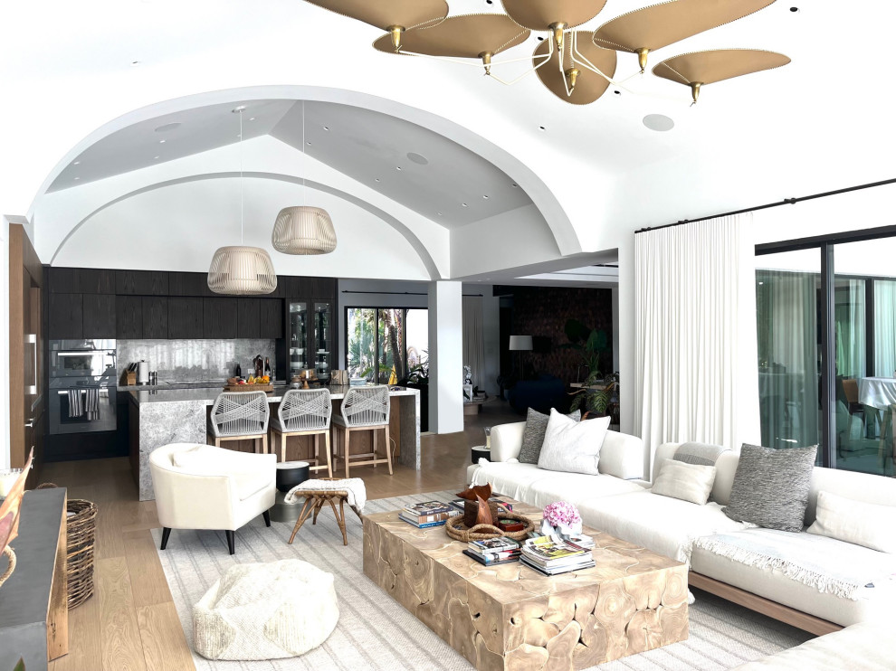Photo of an expansive contemporary open plan games room in Miami with a vaulted ceiling.
