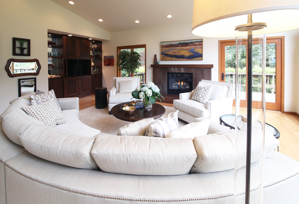 Design ideas for a large transitional enclosed living room in Other with white walls, light hardwood floors, a standard fireplace, a metal fireplace surround and a built-in media wall.