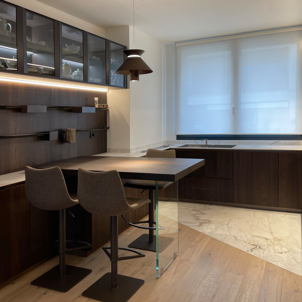 Mid-sized contemporary u-shaped separate kitchen in Milan with a single-bowl sink, beaded inset cabinets, medium wood cabinets, marble benchtops, white splashback, marble splashback, black appliances, marble floors, with island, white floor, white benchtop and recessed.