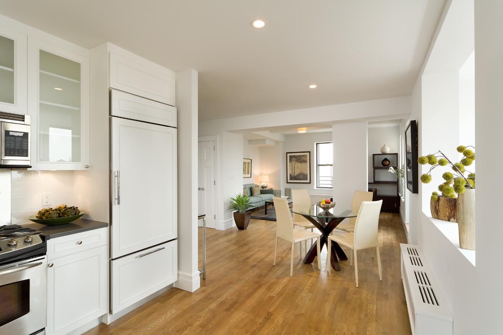 Photo of a contemporary kitchen in New York with panelled appliances.