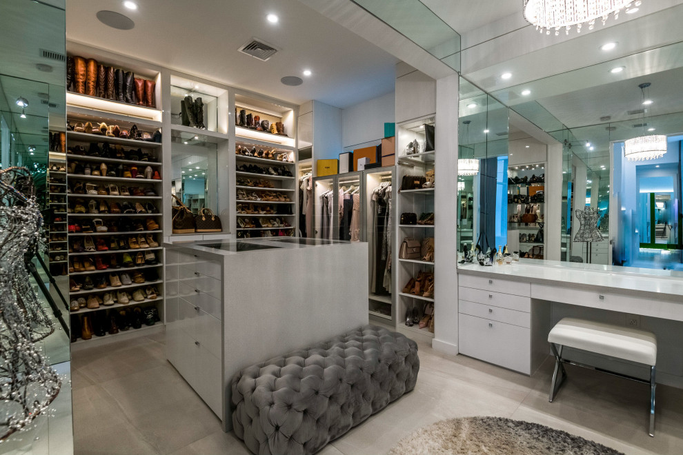 Inspiration for an expansive contemporary women's walk-in wardrobe in Other with open cabinets, white cabinets and grey floor.