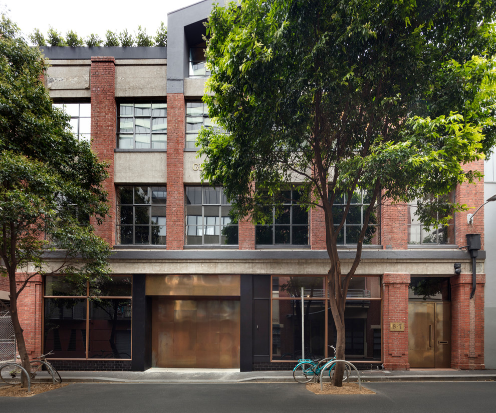 This is an example of an expansive industrial three-storey brick multi-coloured townhouse exterior in Melbourne.