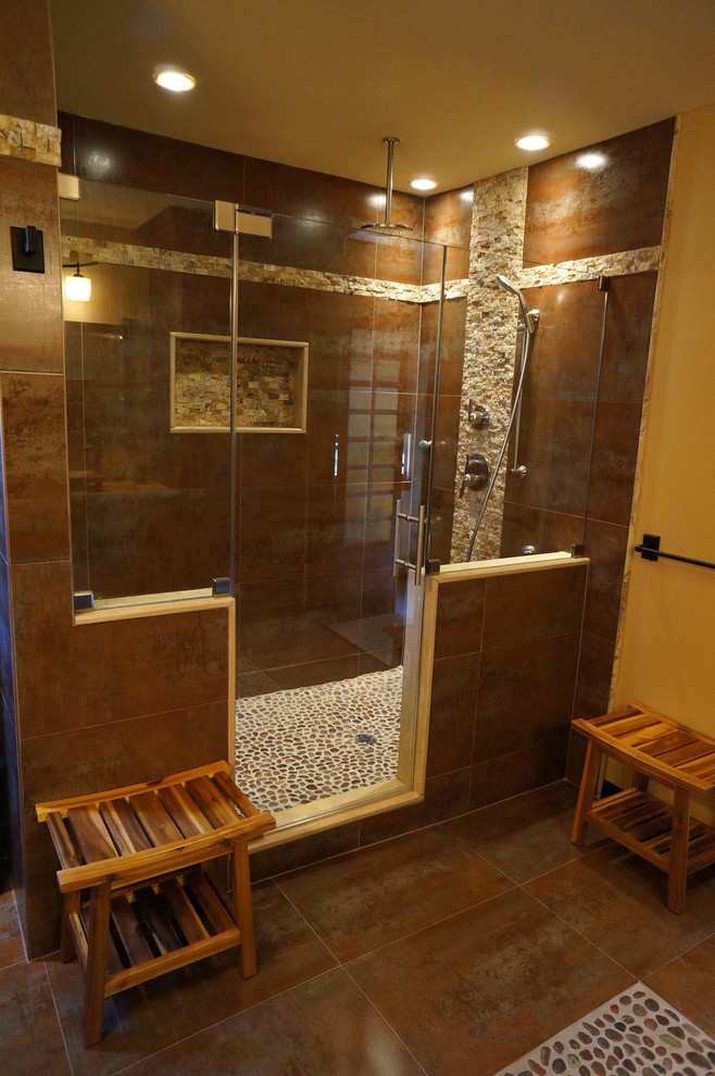 Photo of a mid-sized asian master bathroom in Philadelphia with raised-panel cabinets, black cabinets, an alcove shower, a wall-mount toilet, brown walls, slate floors, a vessel sink and limestone benchtops.