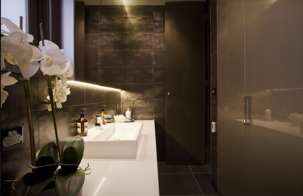 Contemporary bathroom in Sydney with black tile, ceramic tile, ceramic floors, a drop-in sink, granite benchtops and black floor.