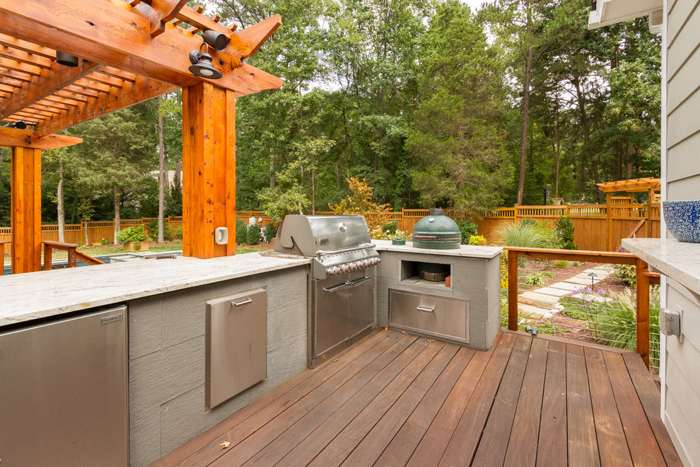 Inspiration for a mid-sized transitional backyard deck in Charlotte with an outdoor kitchen and a pergola.