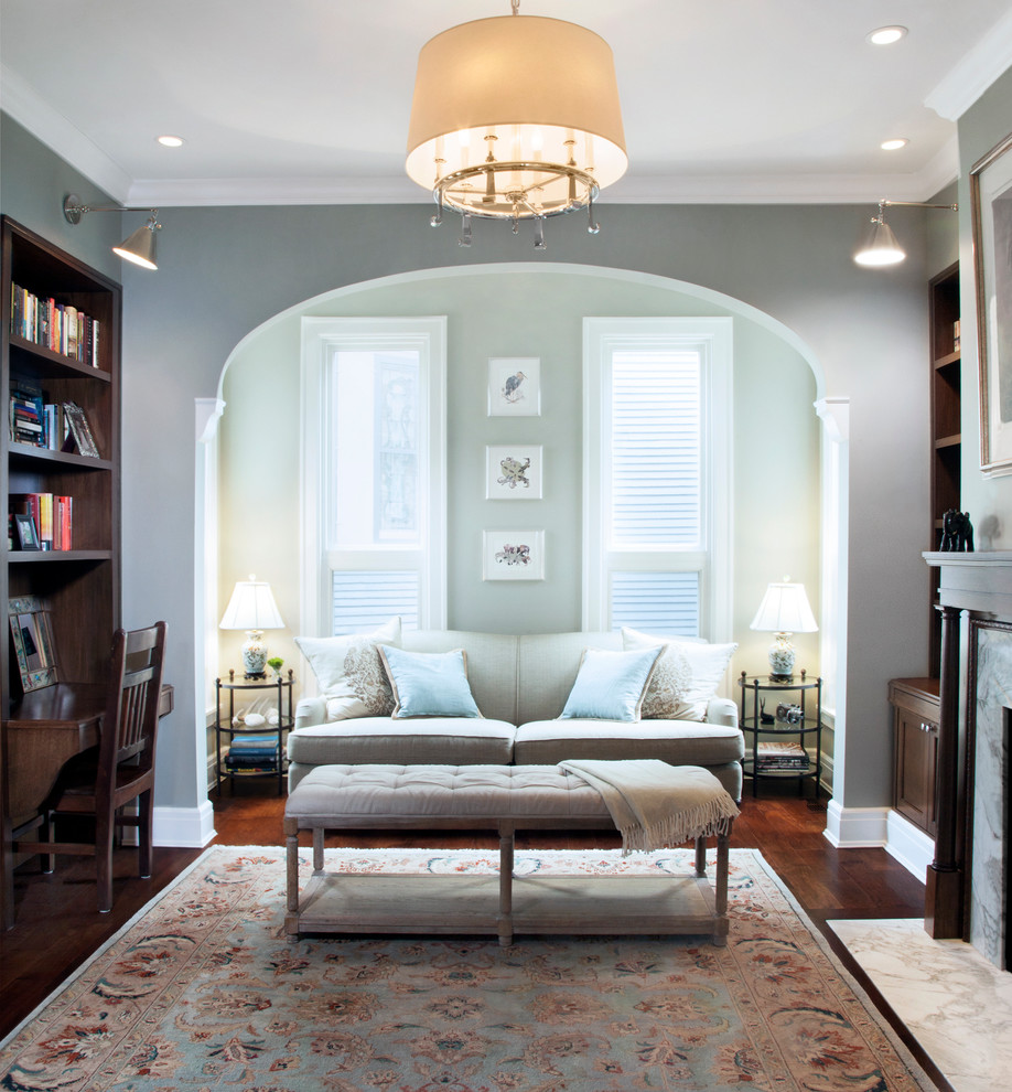 This is an example of a traditional enclosed living room in Chicago with grey walls and dark hardwood floors.