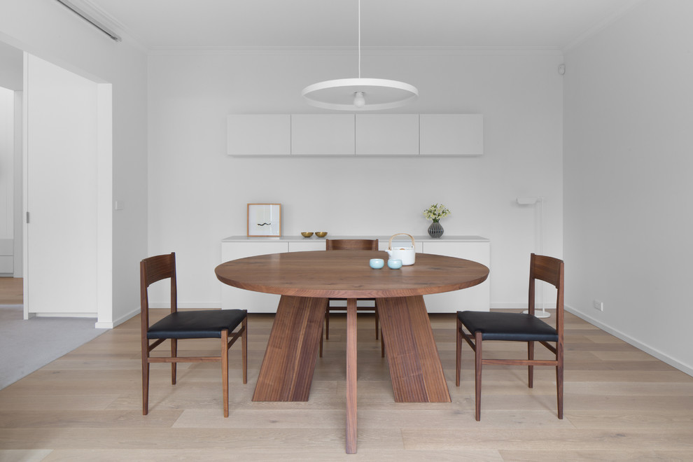 Design ideas for a contemporary dining room in Melbourne with white walls, light hardwood floors and beige floor.