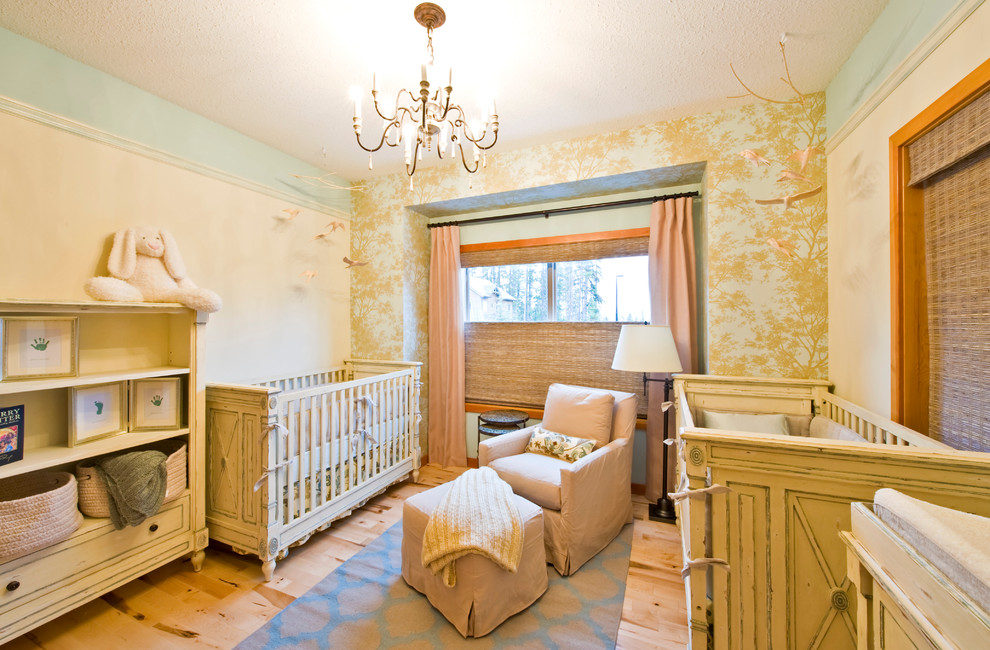 This is an example of a mid-sized traditional gender-neutral nursery in Calgary with beige walls and light hardwood floors.