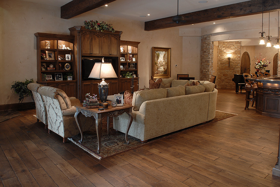 Inspiration for a huge timeless medium tone wood floor, brown floor and exposed beam living room remodel in Chicago with a bar