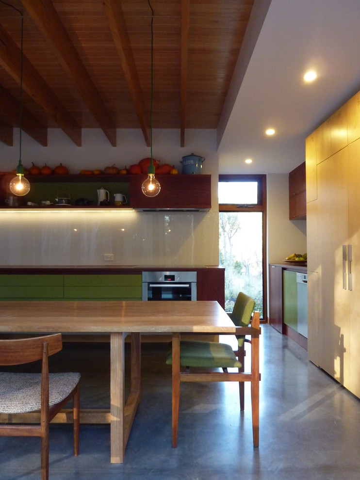 This is an example of a small contemporary l-shaped eat-in kitchen in Canberra - Queanbeyan with an undermount sink, wood benchtops and concrete floors.