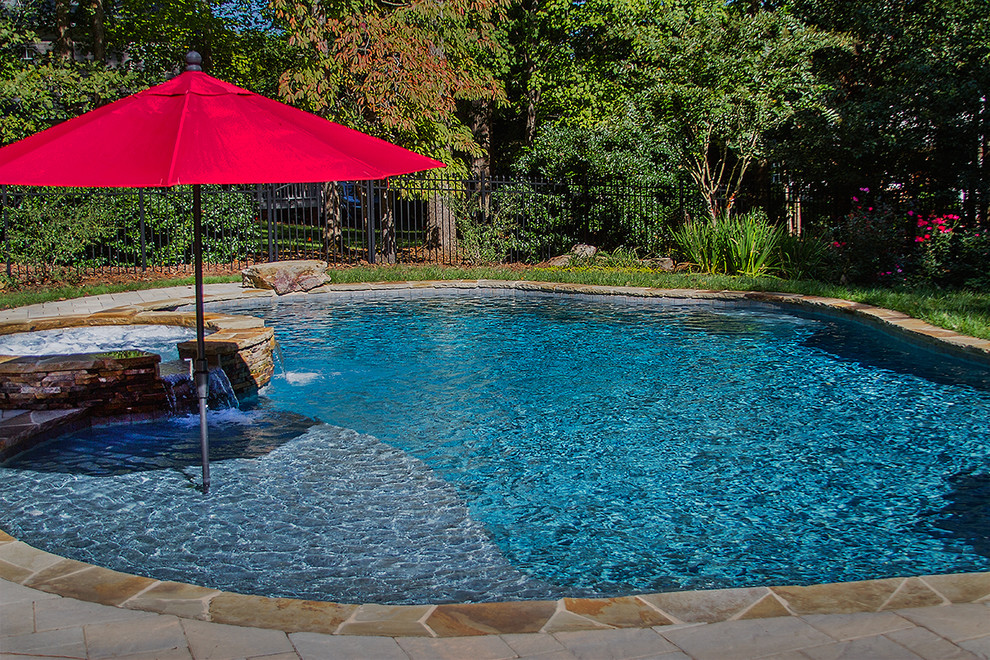 Inspiration for a large country backyard custom-shaped natural pool in Raleigh with a hot tub and concrete pavers.