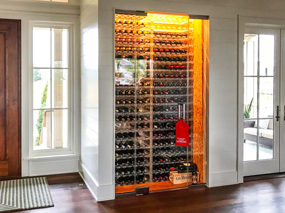 Small transitional wine cellar in San Francisco with cork floors, storage racks and beige floor.