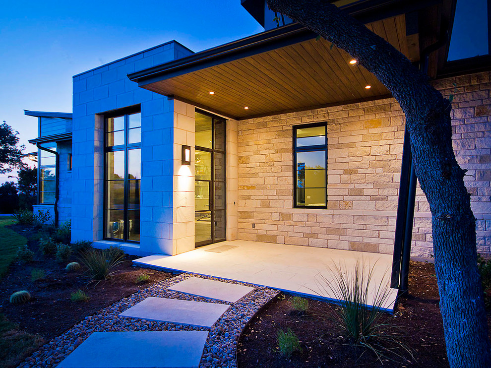 Inspiration for a large contemporary two-storey grey exterior in Austin with stone veneer.