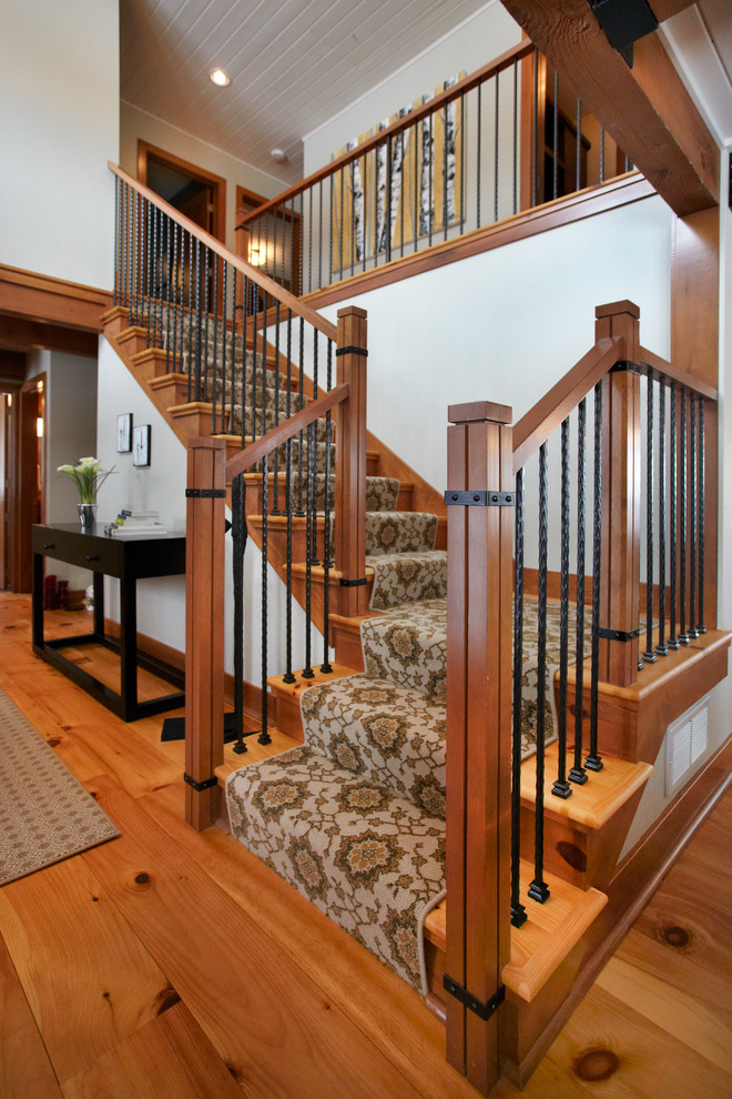 Photo of a mid-sized transitional wood l-shaped staircase in Minneapolis with carpet risers.