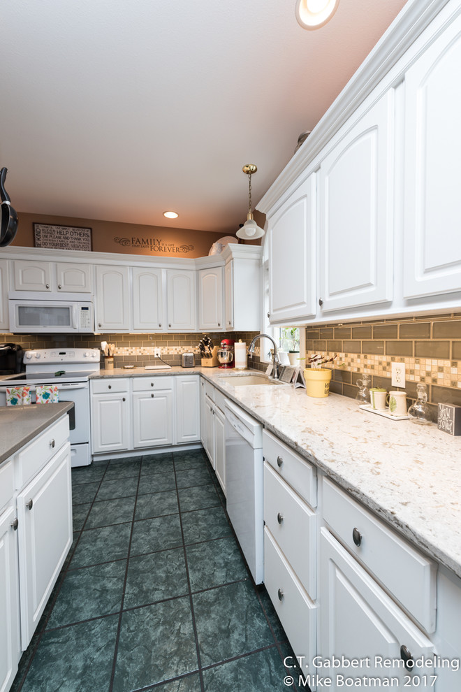 Example of a mid-sized transitional l-shaped kitchen design in Chicago with a double-bowl sink, beaded inset cabinets, white cabinets, quartz countertops, beige backsplash, subway tile backsplash, stainless steel appliances and an island