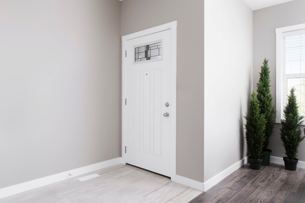 Mid-sized transitional foyer in Calgary with grey walls, ceramic floors, a pivot front door and a white front door.