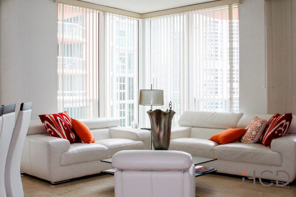 This is an example of a small modern open concept living room in Miami with white walls and marble floors.