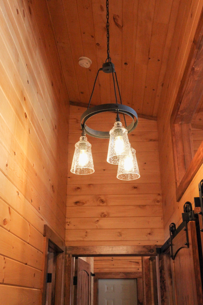Mountain style light wood floor, yellow floor, wood ceiling and wood wall hallway photo