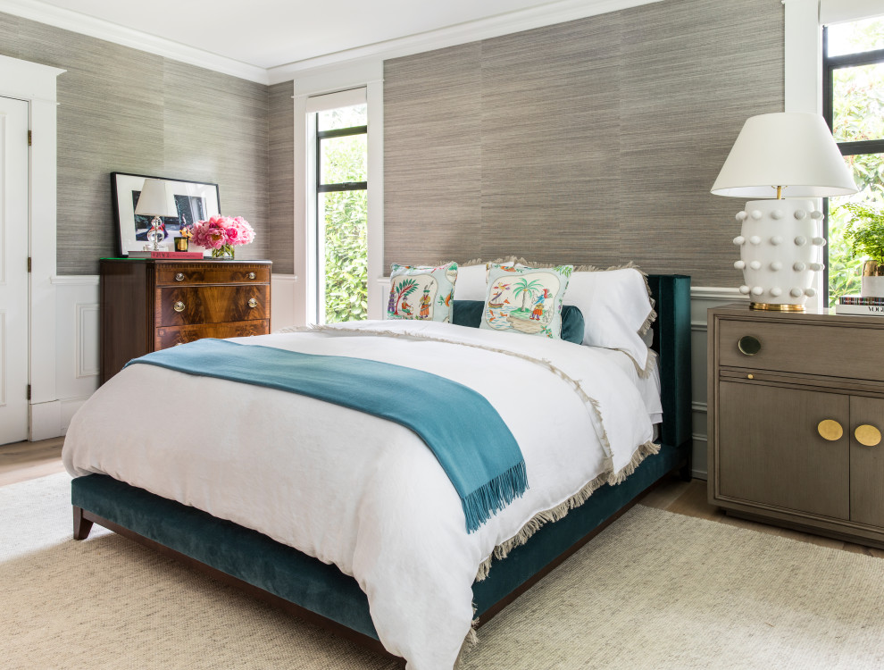 This is an example of a traditional master bedroom in Portland with multi-coloured walls, light hardwood flooring and beige floors.