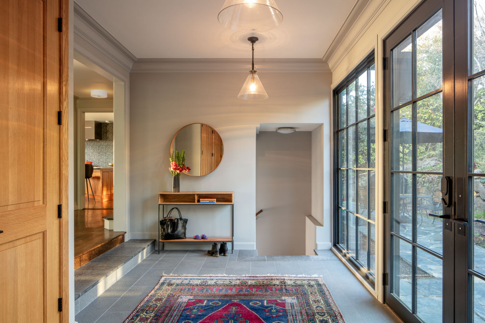 Design ideas for a large transitional foyer in San Francisco with white walls, limestone floors, a double front door, a metal front door and grey floor.