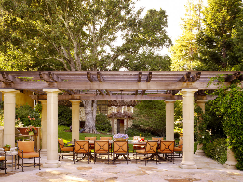 Design ideas for an expansive mediterranean backyard patio in San Francisco with natural stone pavers and a pergola.