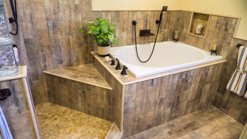 Photo of a mid-sized eclectic master bathroom in San Diego with flat-panel cabinets, light wood cabinets, a drop-in tub, a corner shower, a wall-mount toilet, porcelain tile, yellow walls, porcelain floors, an undermount sink and marble benchtops.