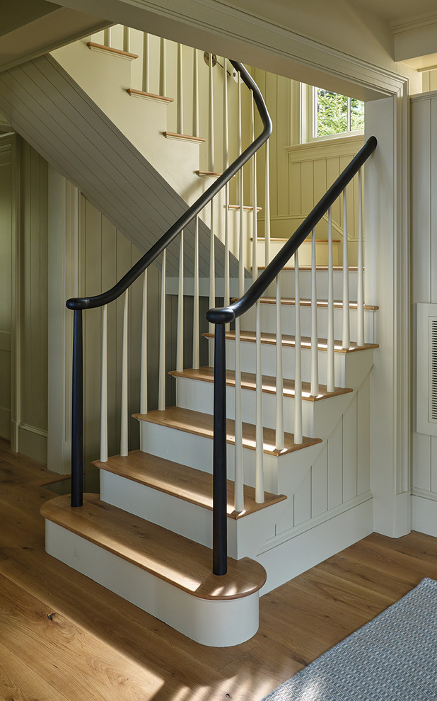 Photo of a beach style staircase in Portland Maine with wood risers and wood railing.
