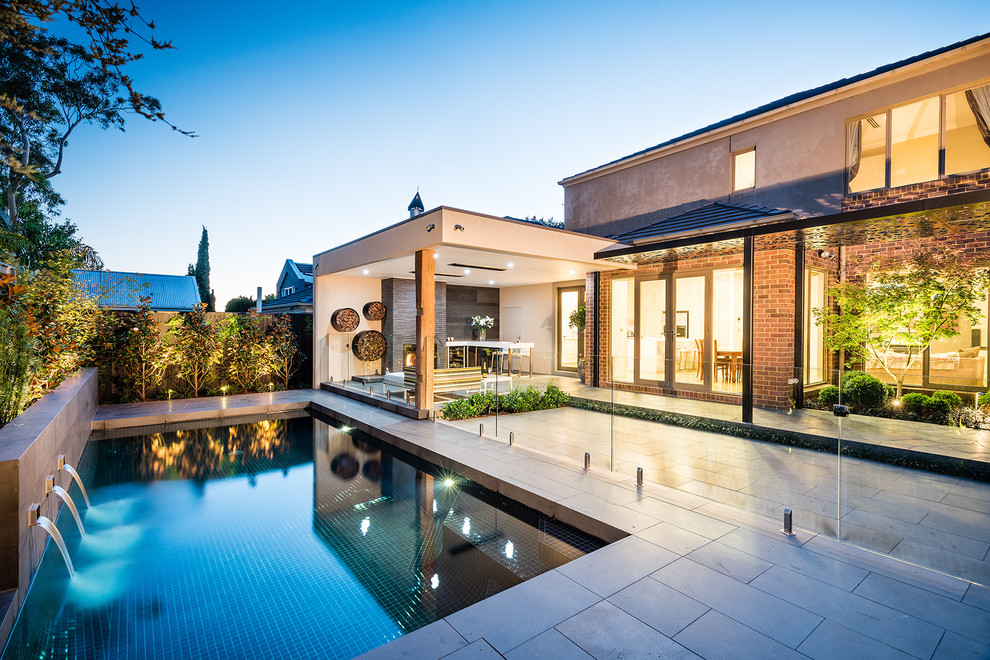 Design ideas for a mid-sized contemporary two-storey brick beige exterior in Melbourne with a hip roof.