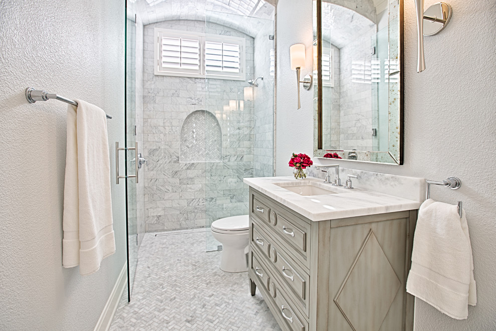 Inspiration for a small transitional marble floor walk-in shower remodel in Austin with raised-panel cabinets, gray cabinets, gray walls, an undermount sink and marble countertops