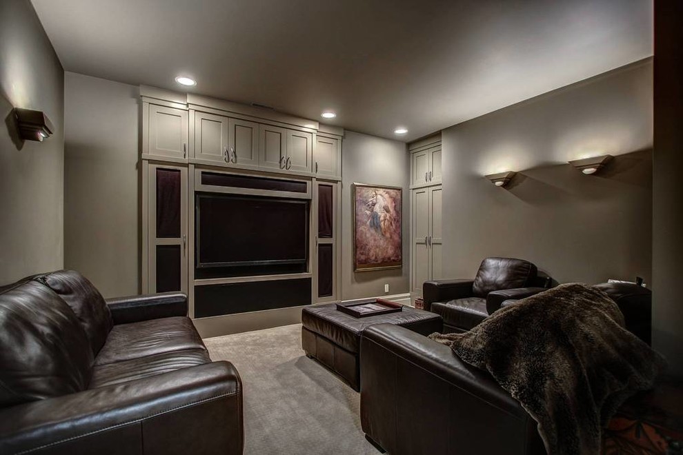This is an example of a mid-sized arts and crafts walk-out basement in New York with grey walls, carpet, a standard fireplace, a stone fireplace surround and beige floor.