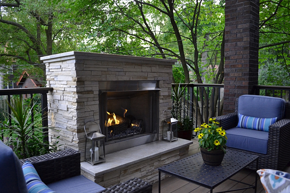 Mid-sized transitional backyard deck photo in St Louis with a fireplace and a roof extension