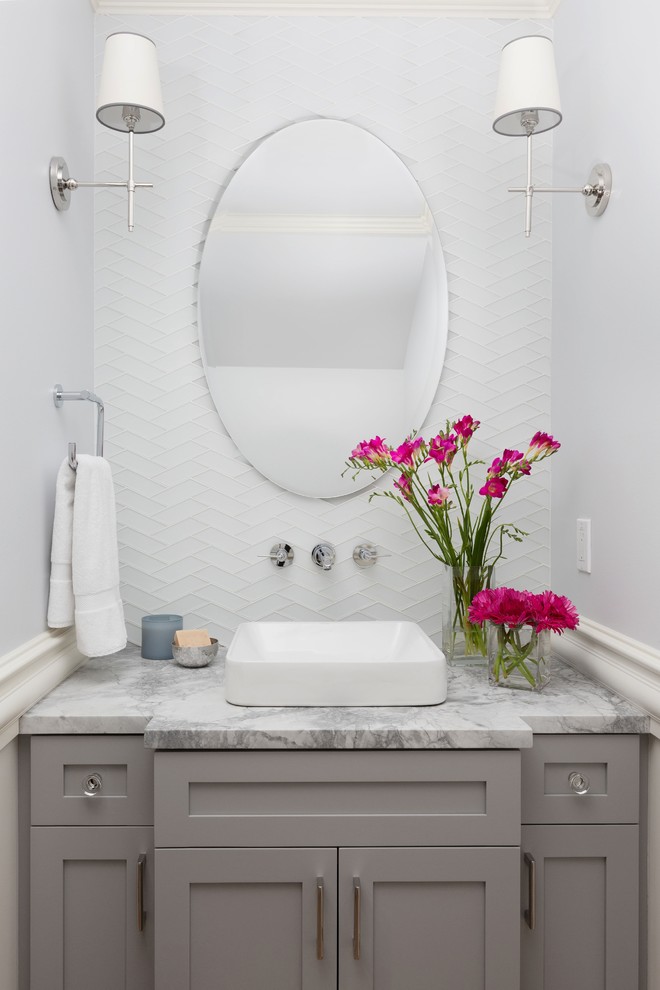 Design ideas for a transitional powder room with shaker cabinets, grey cabinets, white tile, glass tile, grey walls, a vessel sink, marble benchtops and grey benchtops.