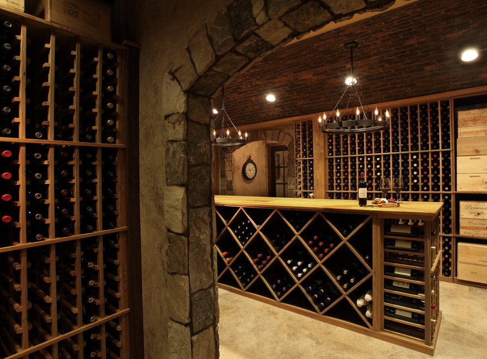 Photo of an expansive country wine cellar in Atlanta with marble floors, storage racks and beige floor.