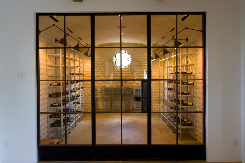Mid-sized contemporary wine cellar in Santa Barbara with concrete floors and storage racks.