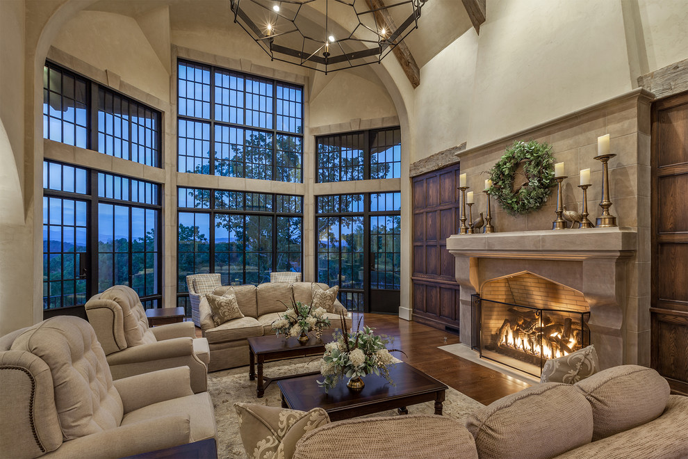 Design ideas for a large country formal open concept living room in Other with medium hardwood floors, a standard fireplace, a stone fireplace surround, beige walls and no tv.