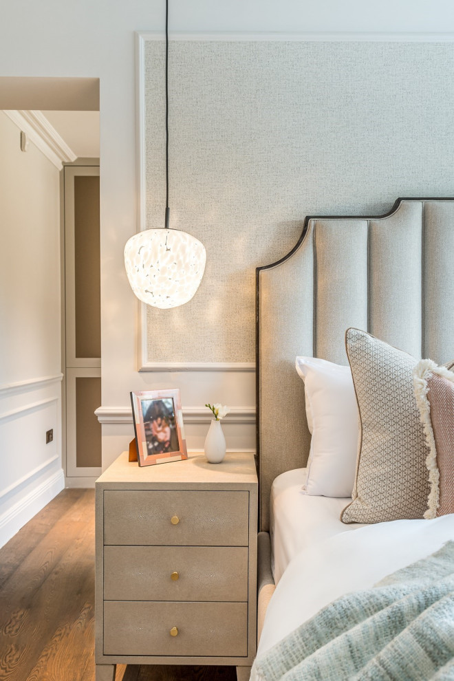 Design ideas for a medium sized classic master bedroom in Hertfordshire with beige walls, dark hardwood flooring, panelled walls and feature lighting.