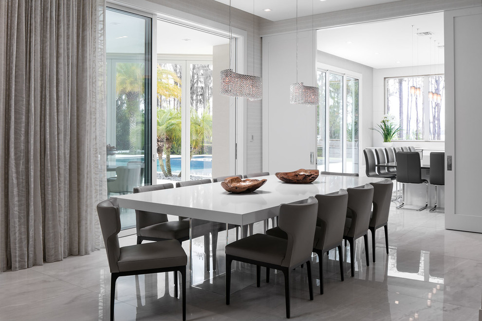 Photo of a contemporary dining room in Orlando with grey walls and grey floor.