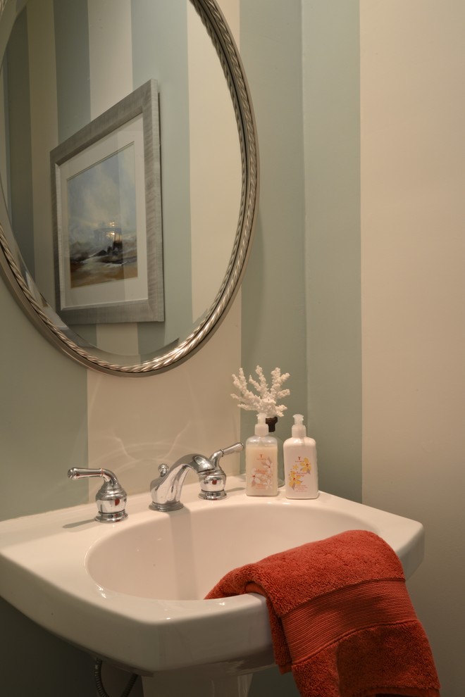 Photo of a beach style powder room in San Diego with blue walls, dark hardwood floors and a pedestal sink.