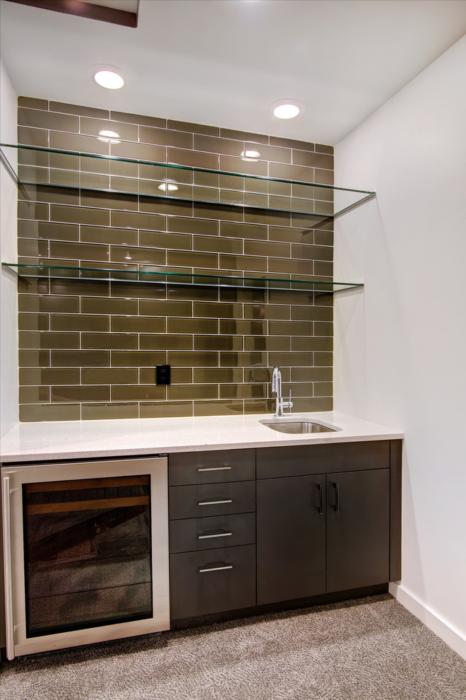 This is an example of a small contemporary single-wall wet bar in Albuquerque with an undermount sink, flat-panel cabinets, dark wood cabinets, quartz benchtops, brown splashback, subway tile splashback and carpet.