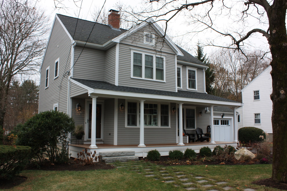 This is an example of a small traditional two-storey grey house exterior in Boston with wood siding, a gable roof and a shingle roof.