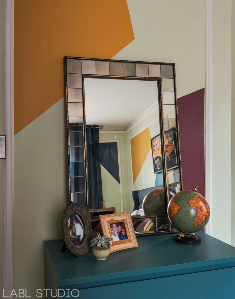 Inspiration for a mid-sized eclectic master bedroom in New York with multi-coloured walls and medium hardwood floors.