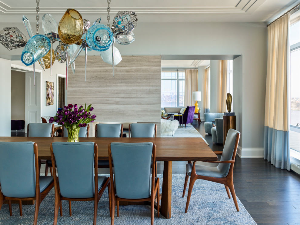 Transitional dining room in New York with grey walls, dark hardwood floors and brown floor.