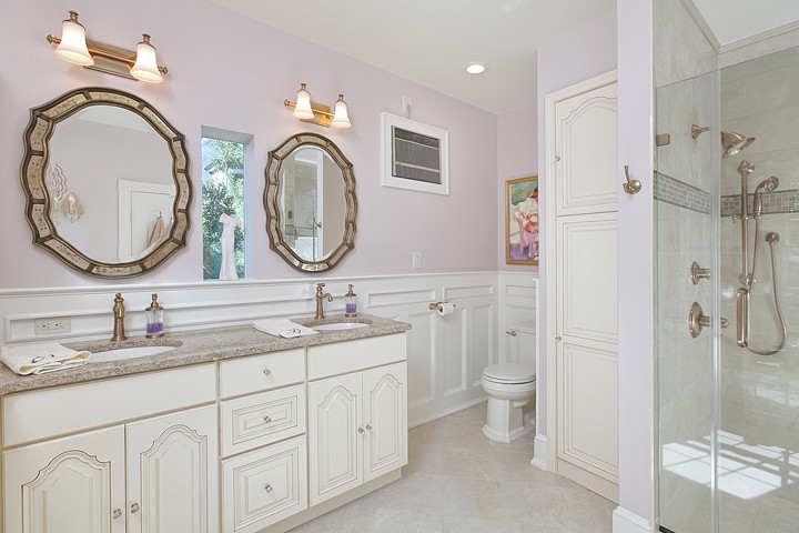Photo of a large traditional master bathroom in Philadelphia with raised-panel cabinets, engineered quartz benchtops, an undermount sink, white cabinets, an alcove shower, a two-piece toilet, gray tile, porcelain tile, purple walls and porcelain floors.