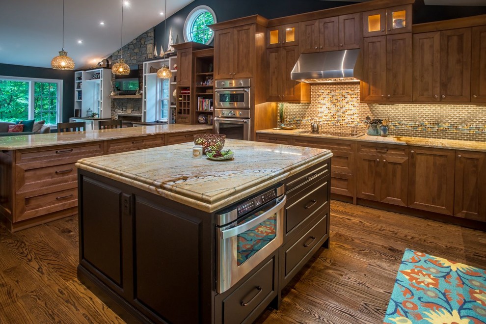 Design ideas for a large arts and crafts u-shaped open plan kitchen in DC Metro with shaker cabinets, medium wood cabinets, limestone benchtops, glass tile splashback, stainless steel appliances, medium hardwood floors, with island and beige splashback.