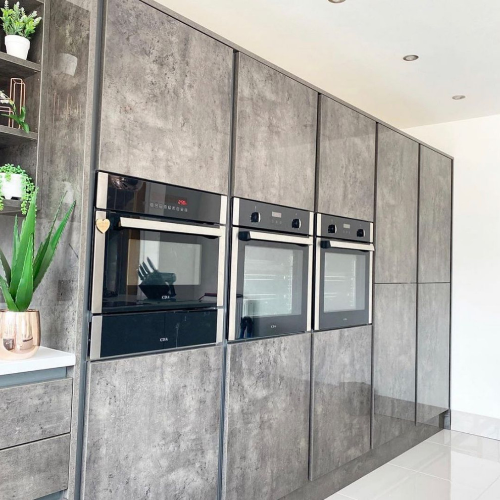 Design ideas for a large contemporary l-shaped open plan kitchen in London with a submerged sink, beaded cabinets, grey cabinets, quartz worktops, white splashback, granite splashback, black appliances, porcelain flooring, an island, white floors, white worktops and a coffered ceiling.