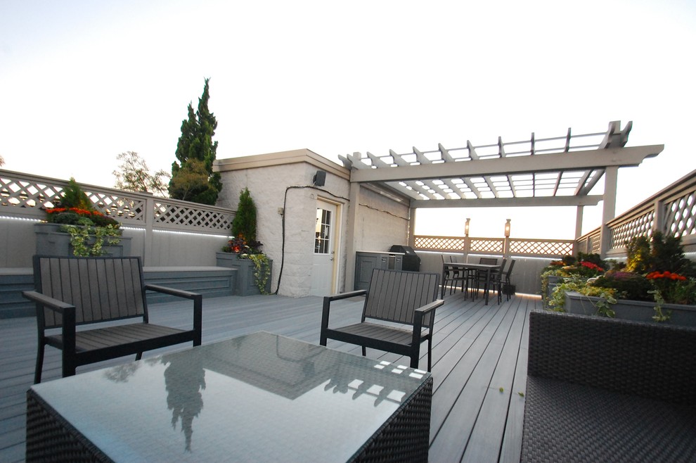 Inspiration for a large transitional rooftop outdoor kitchen deck remodel in Chicago with a pergola