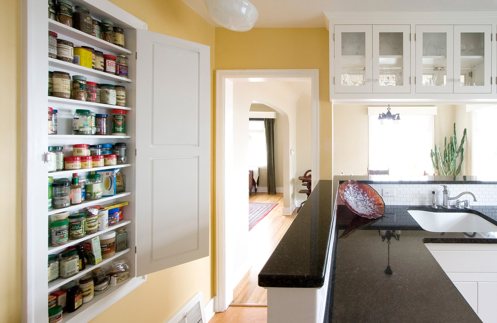 Inspiration for a small transitional u-shaped linoleum floor eat-in kitchen remodel in Seattle with an undermount sink, shaker cabinets, white cabinets, granite countertops, white backsplash, subway tile backsplash, stainless steel appliances and a peninsula
