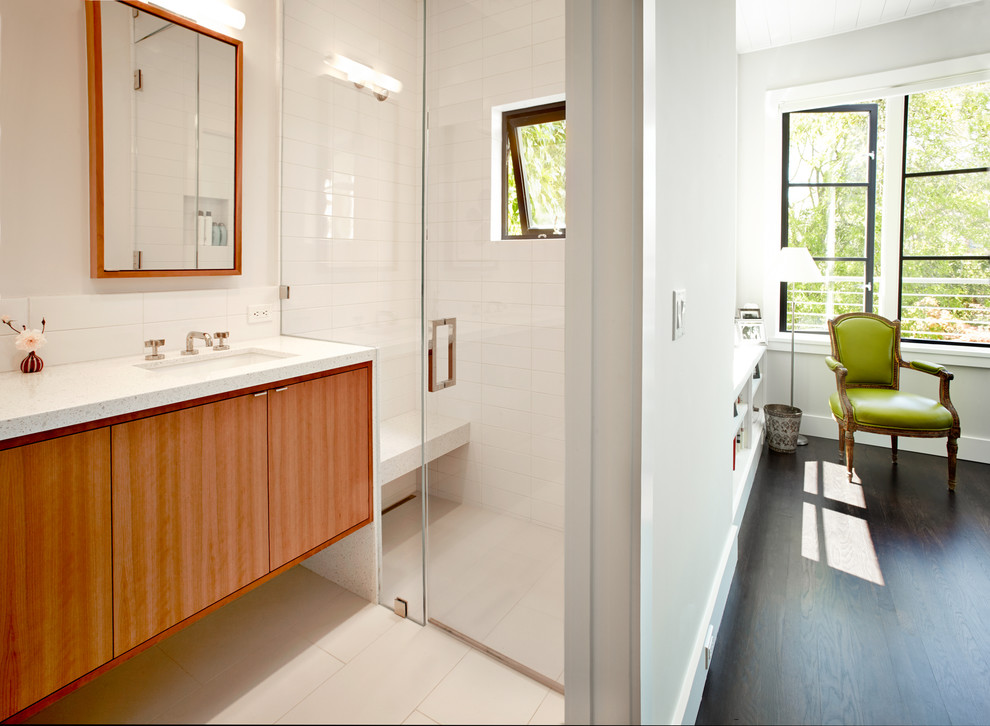 Design ideas for a mid-sized contemporary master bathroom in San Francisco with flat-panel cabinets, medium wood cabinets, white tile, white walls, a drop-in sink, quartzite benchtops, ceramic tile, a curbless shower and a hinged shower door.