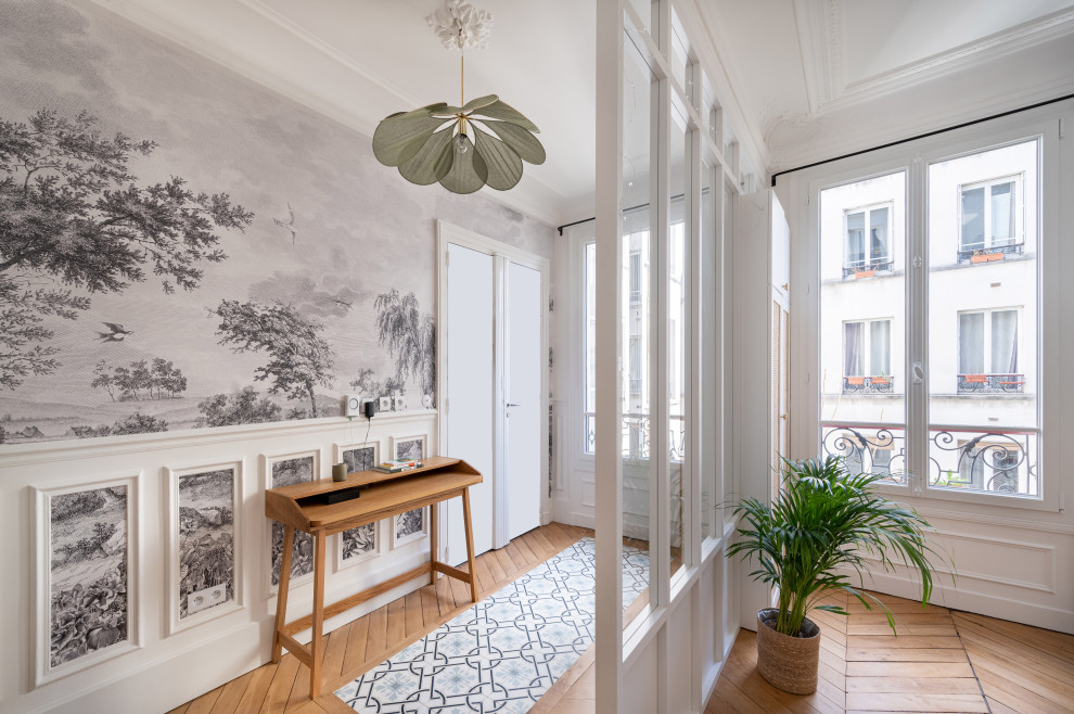 Design ideas for a mid-sized contemporary foyer in Paris with white walls, light hardwood floors, a double front door, a white front door and wallpaper.