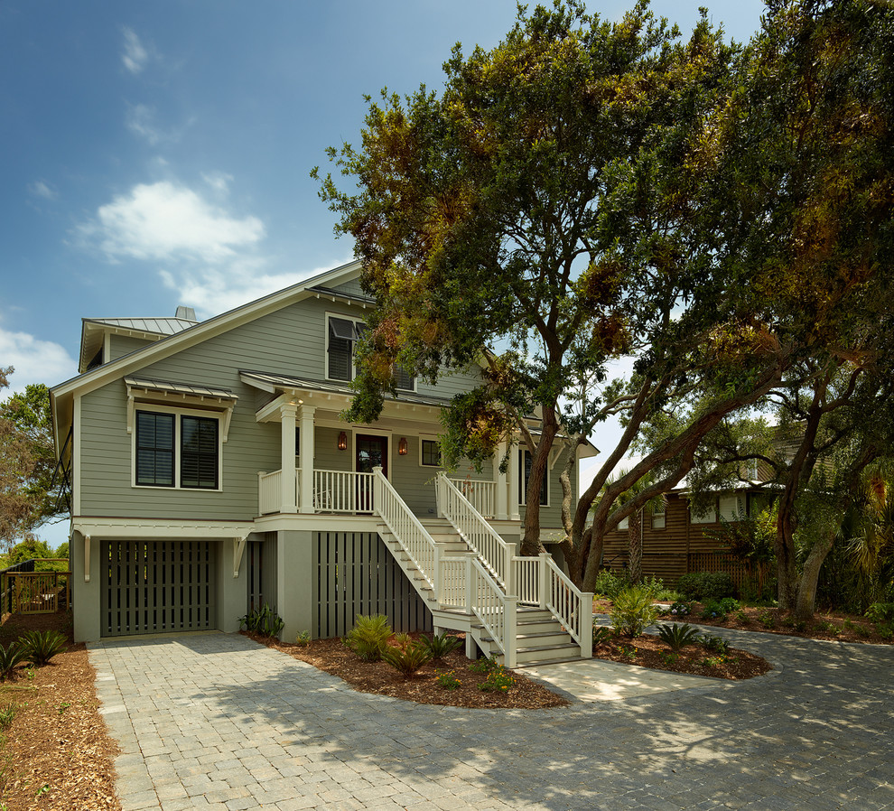 This is an example of a tropical exterior in Charleston with wood siding.